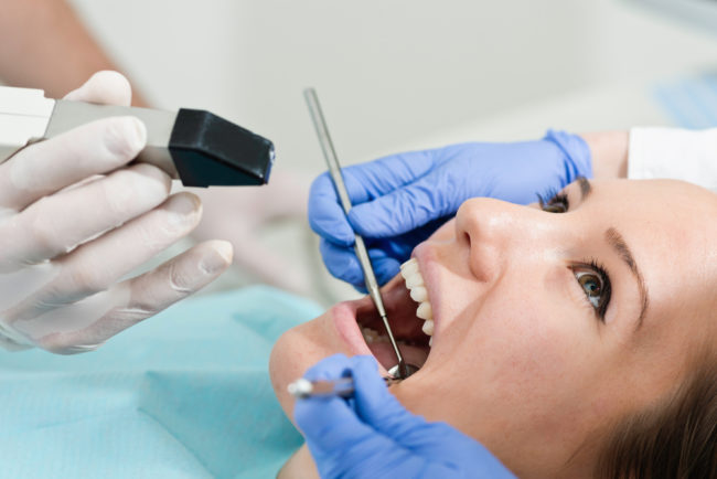 Dentist using intraoral camera